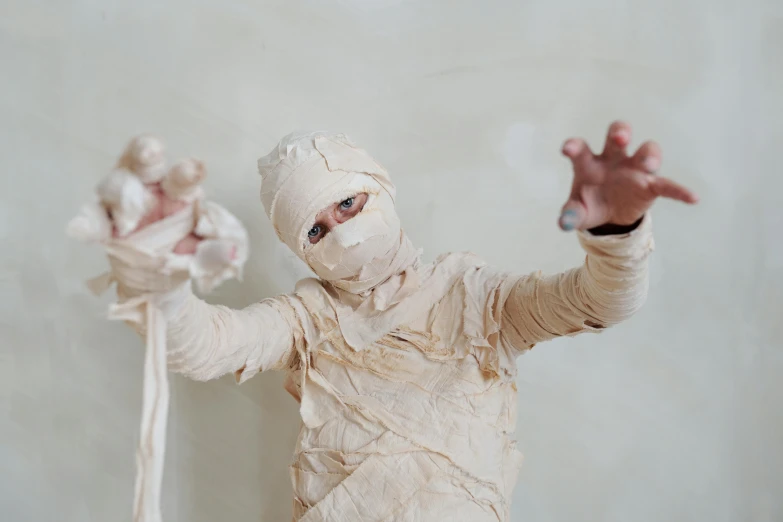 a close up of a person in a costume, pexels contest winner, disposal mummy, made of silk paper, triumphant pose, lachlan bailey