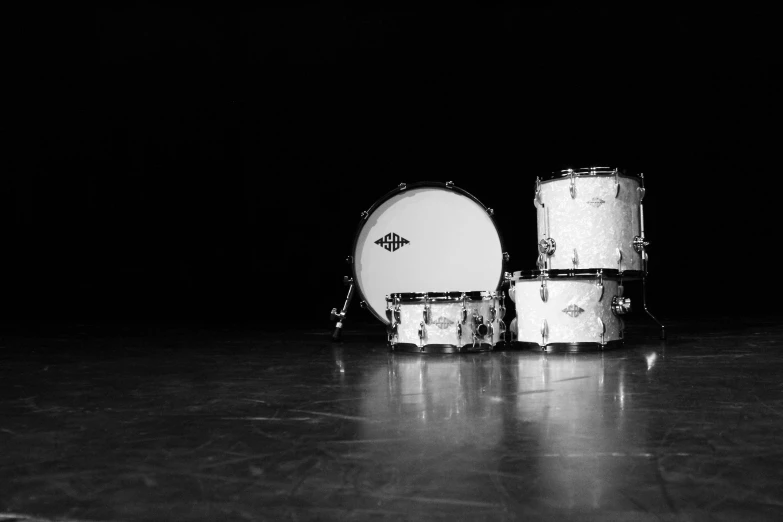 a couple of drums sitting on top of a floor, a black and white photo, by Jan Rustem, white diamonds, desktop wallpaper, three - point lighting, featured