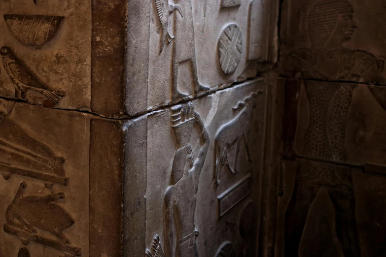 a close up of a wall with carvings on it, egyptian art, by Jessie Algie, pexels contest winner, inside the sepulchre, evening light, grey, the narthex