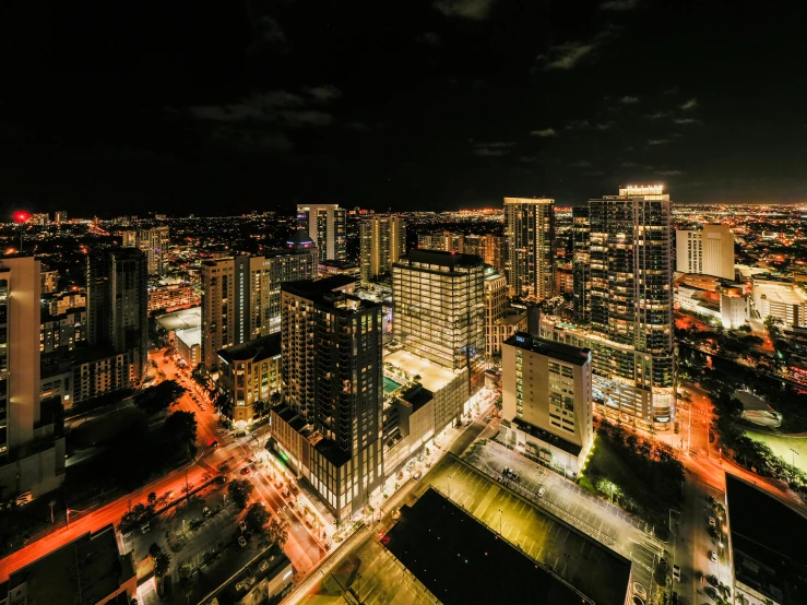 an aerial view of a city at night, by Austin English, pexels contest winner, happening, palms and miami buildings, panoramic, night time footage