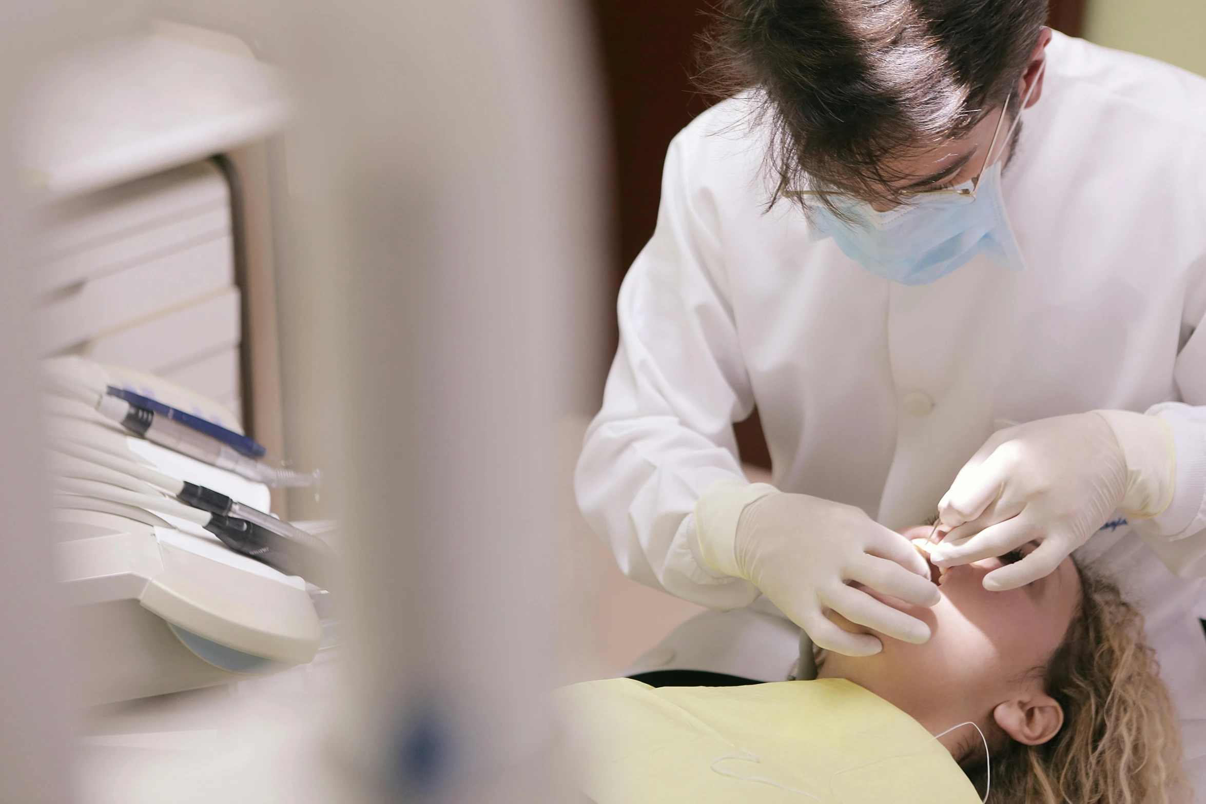 a woman getting her teeth examined by a dentist, by Jang Seung-eop, fan favorite, unblur, teaser, middle shot