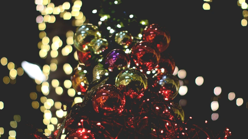 a close up of a christmas tree with lights in the background, by Julia Pishtar, pexels, process art, disco balls, olive green and venetian red, night outside, 15081959 21121991 01012000 4k