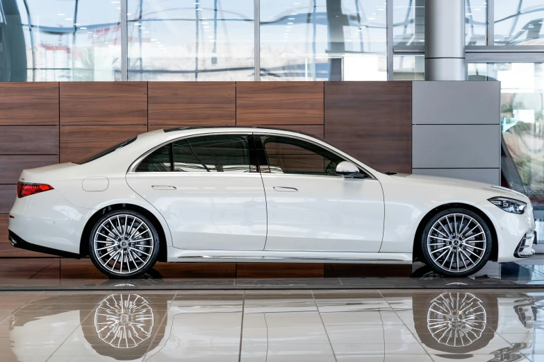 a white car is parked in a showroom, profile image, 2263539546], mercedez benz, ground - level medium shot