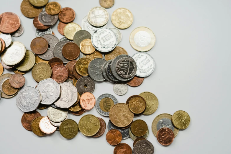 a pile of coins sitting on top of a table, various items, zoomed out, thumbnail, high quality product image”