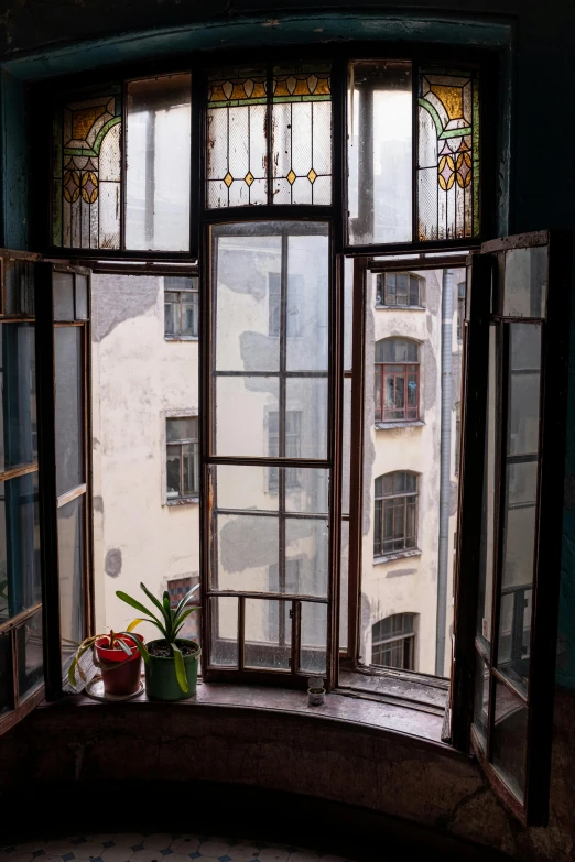 a window with a potted plant in front of it, inspired by Mihály Munkácsy, art nouveau, view from high, shanghai, abandoned prague, full room view