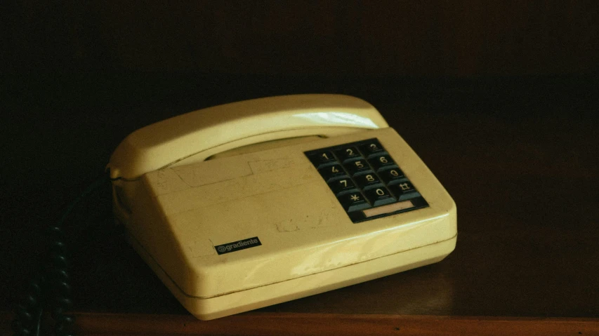 a white telephone sitting on top of a wooden table, from 1977, faded and dusty, christopher alexander, skeuomorphic