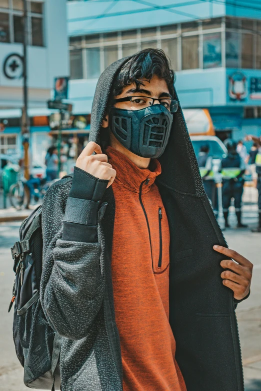 a man wearing a mask on a city street, pexels contest winner, wearing netrunner clothing, student, carrying survival gear, avatar image