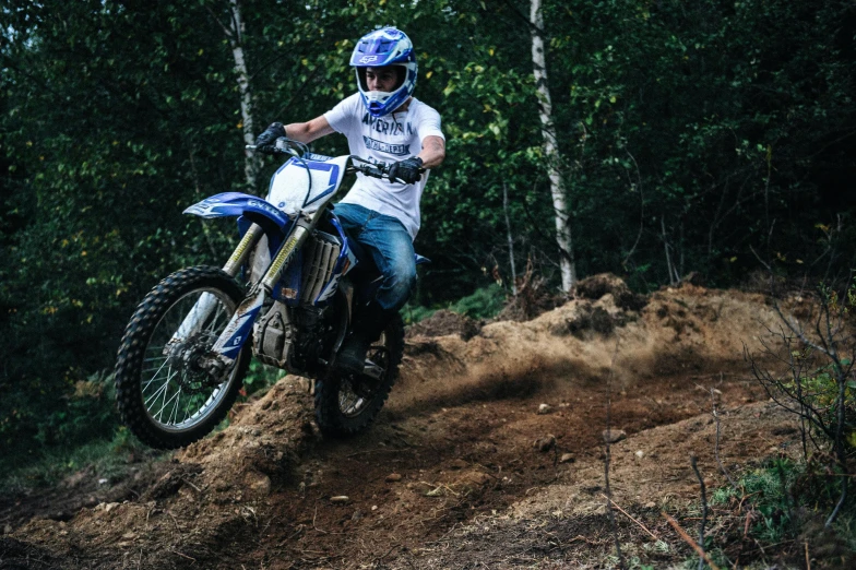 a man riding on the back of a dirt bike, unsplash, figuration libre, avatar image, finland, sassy pose, low quality photo