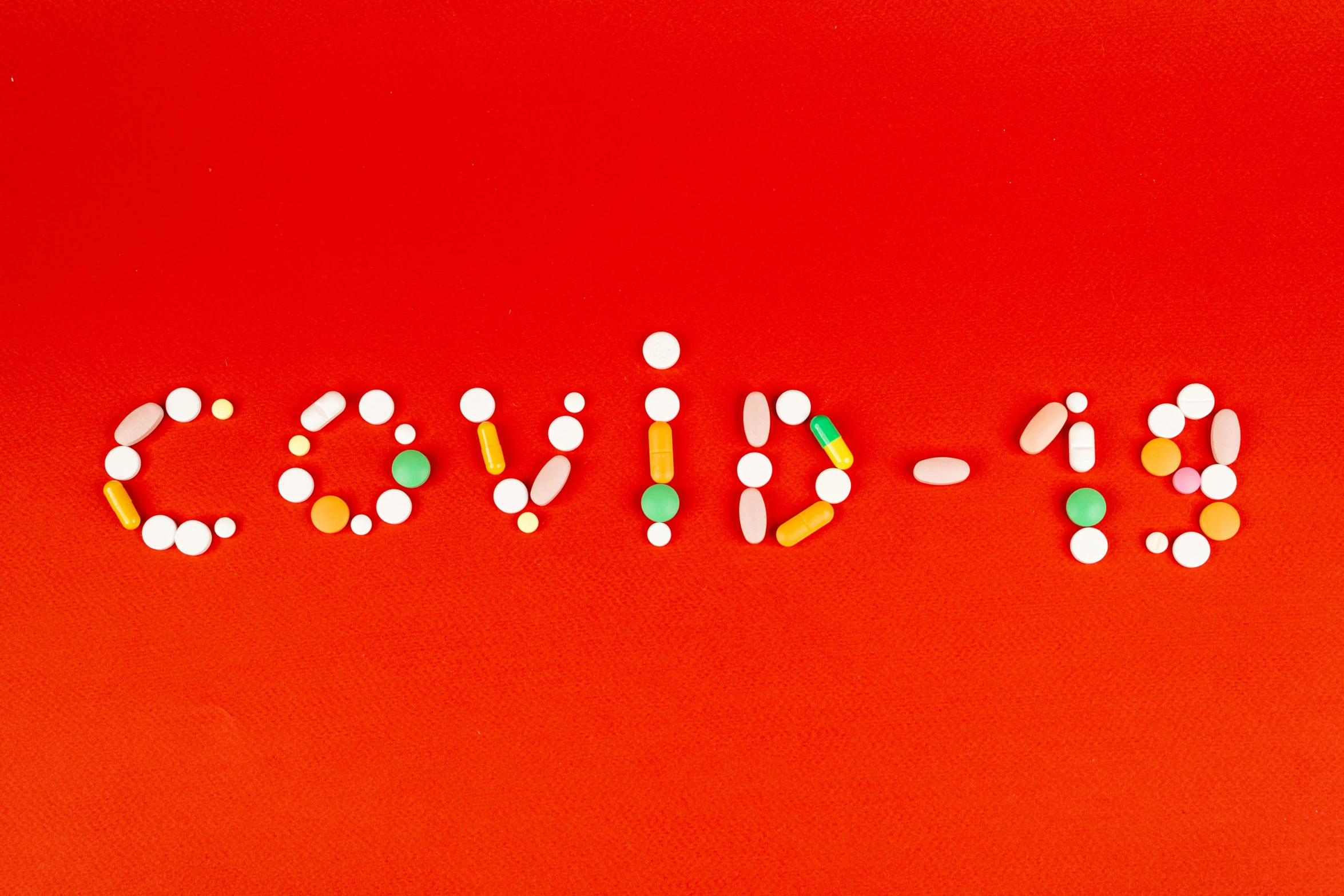 the word candy spelled out of pills on a red background, an album cover, by Olivia Peguero, pexels, antipodeans, poster of corona virus, covid, micro - organisms, limited edition