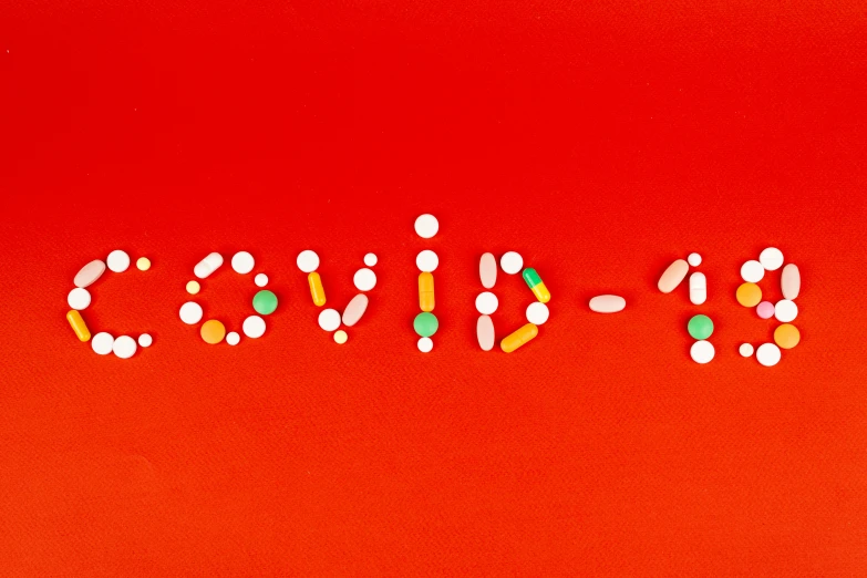 the word candy spelled out of pills on a red background, an album cover, by Olivia Peguero, pexels, antipodeans, poster of corona virus, covid, micro - organisms, limited edition
