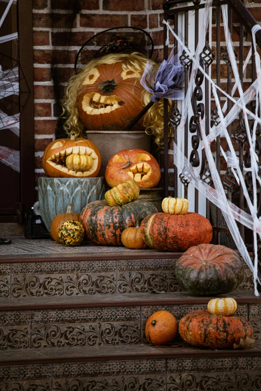 pumpkins and gourds sit on the steps of a house, a portrait, by Everett Warner, pexels, highly detailed carvings, webs, brooklyn, slide show