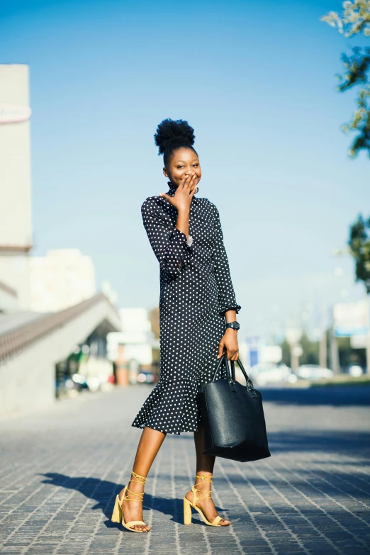 a woman walking down a street talking on a cell phone, polkadots, curated collections, essence, office clothes