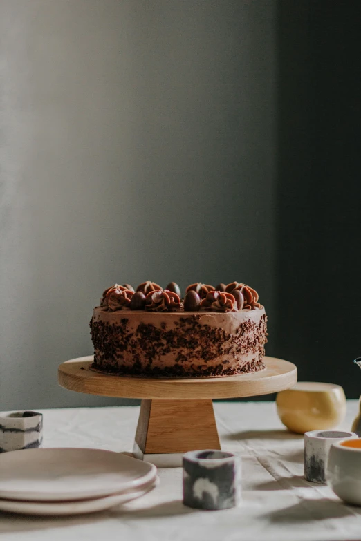 a chocolate cake sitting on top of a table, pexels contest winner, hyperrealism, celebration of coffee products, on a marble pedestal, walnut wood, caramel. rugged