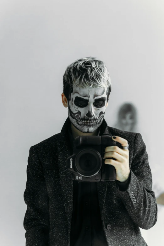 a man taking a picture of himself with a camera, inspired by Taro Yamamoto, pexels contest winner, lowbrow, skull face paint, grey alien, a man wearing a black jacket, ken kaneki