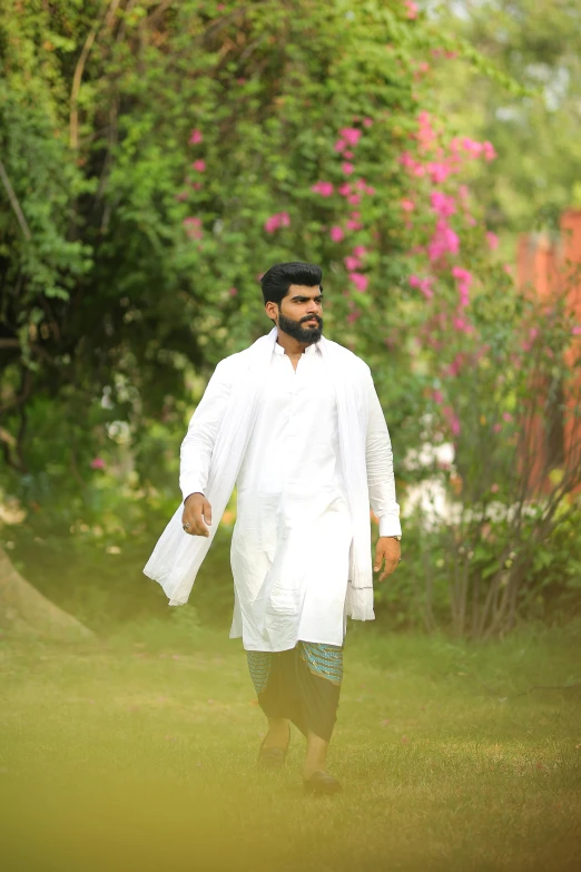 a man walking across a lush green field, inspired by Bholekar Srihari, renaissance, wearing lab coat, wearing off - white style, ( ( theatrical ) ), dhamphir