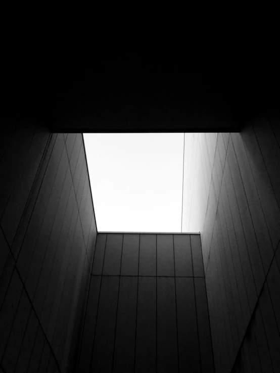 a black and white photo of a skylight in a building, by Karl Buesgen, light and space, square shapes, ((monolith)), yoh yoshinori, conor walton