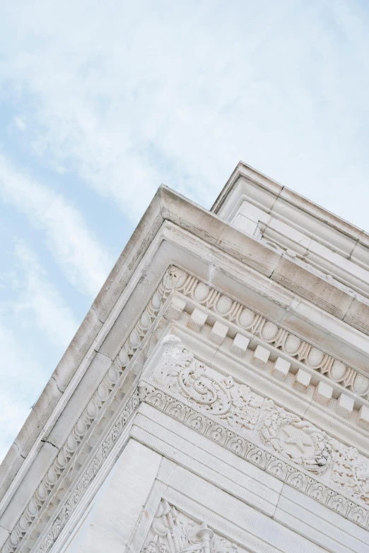 a clock that is on the side of a building, a marble sculpture, inspired by Rachel Whiteread, trending on unsplash, neoclassicism, looking up into the sky, large overhangs, chiseled jawline, intricate ornamentation