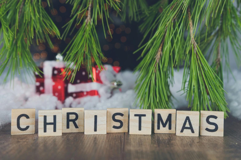 a wooden block with the word christmas spelled on it, pexels, square, background image, 2 0 5 6, fan favorite