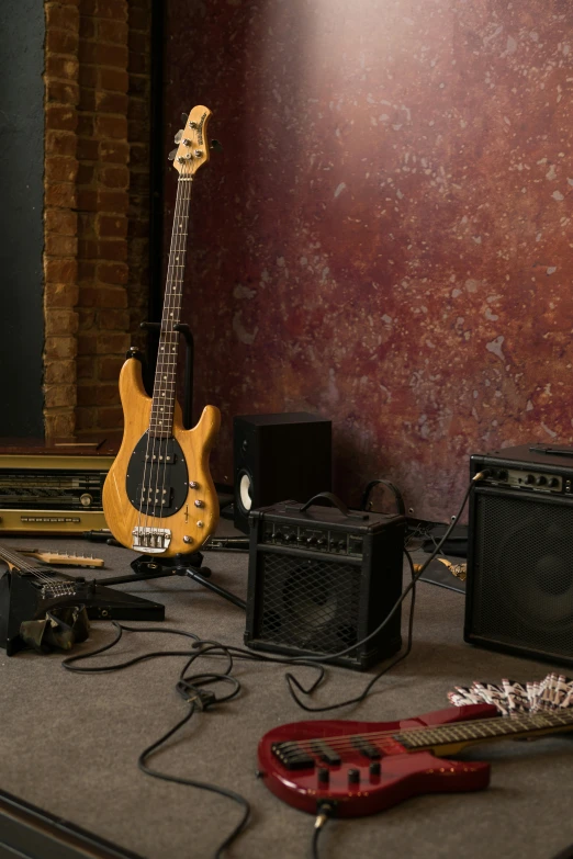 a group of guitars sitting on top of a table, boombox, indoor scene, commercially ready, subwoofer