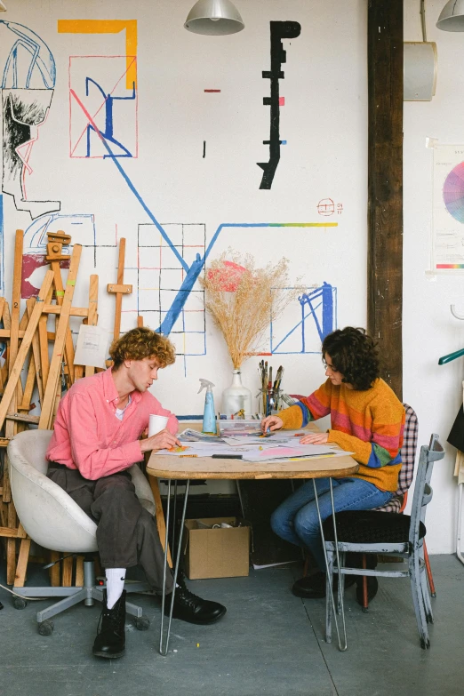 a couple of people that are sitting at a table, arbeitsrat für kunst, vibrant aesthetic, design studio, lesbians, art station ”