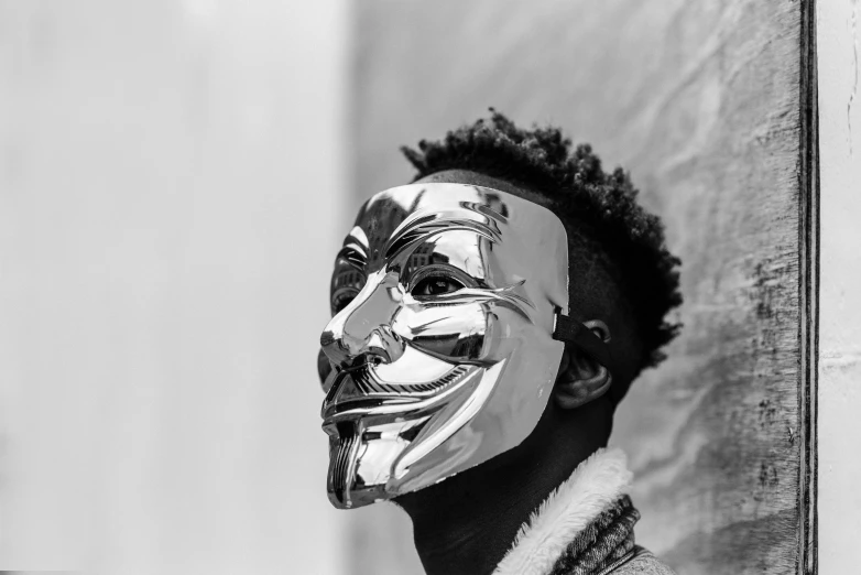 a black and white photo of a man wearing a mask, by Emma Andijewska, pexels contest winner, afrofuturism, diamond plated superhero, donald glover, hacker, clear [bronze] face