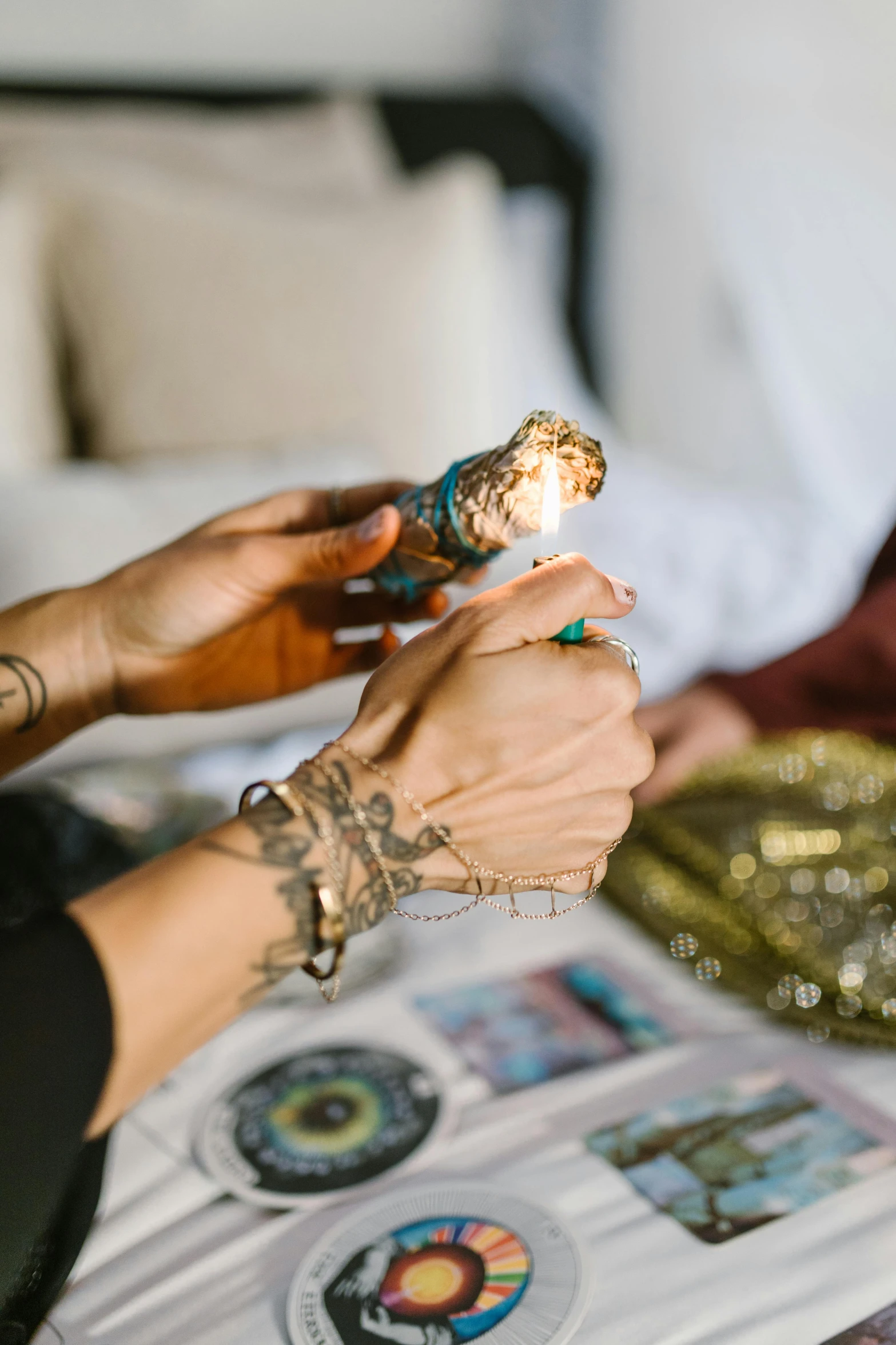 a couple of women sitting on top of a bed, a tattoo, trending on pexels, casting a flame spell, justina blakeney, hamsa hand, smoking weed