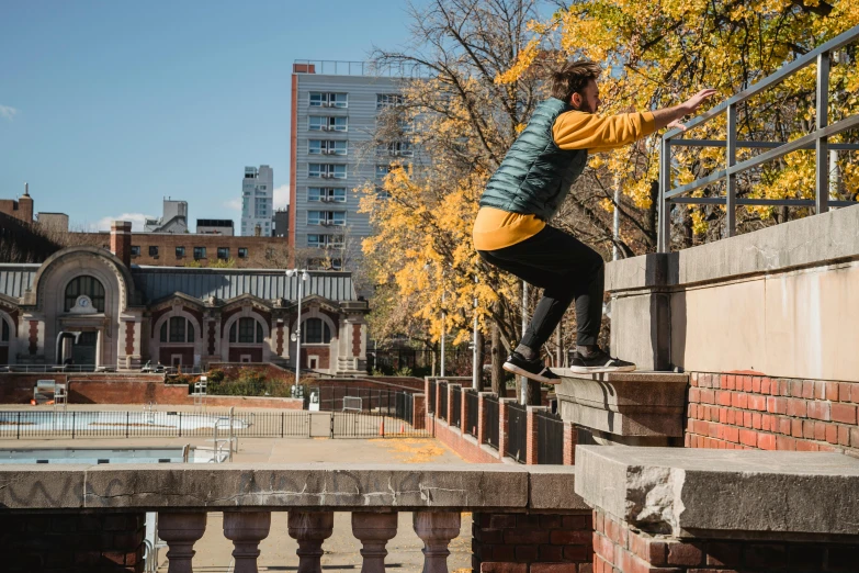 a man flying through the air while riding a skateboard, unsplash, graffiti, tall terrace, autumnal, parks and public space, lachlan bailey