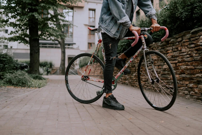 a man standing next to a bike on a sidewalk, pexels contest winner, student, background image, long legs, transparent background