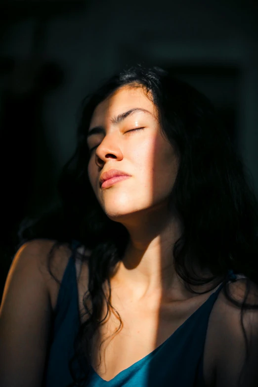 a woman that is sitting down with her eyes closed, pexels contest winner, light and space, sweaty face, asian sun, mixed-race woman, sleepy expression