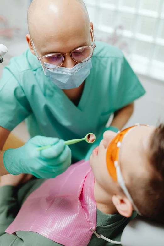 a man getting his teeth examined by a dentist, a picture, shutterstock, children's, wearing a mask, saturated colorized, thumbnail