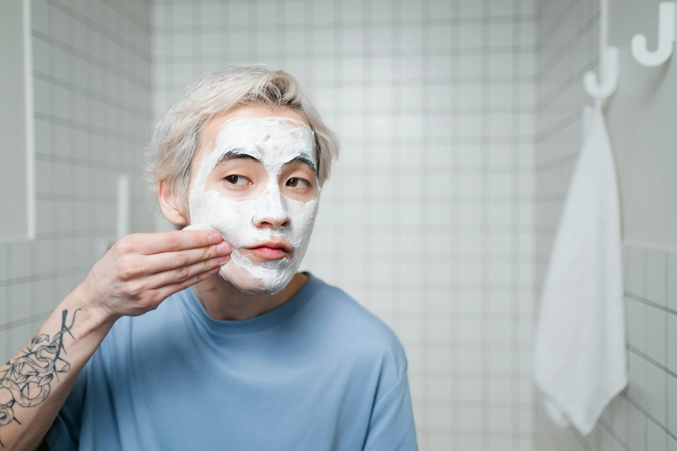 a man shaving his face in a bathroom, by Julia Pishtar, wearing noh theatre mask, kim doyoung, square facial structure, avatar image