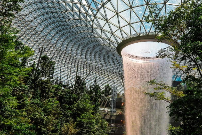 the inside of a building with a waterfall coming out of it, inspired by Buckminster Fuller, pexels contest winner, cloud forest in background, calatrava, the empress’ swirling gardens, 🎀 🧟 🍓 🧚