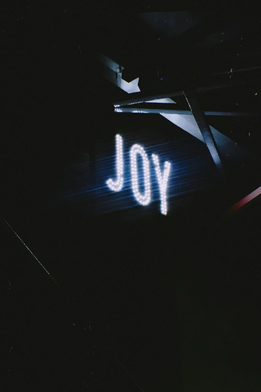 a neon sign that says you in a dark room, an album cover, inspired by Joy Garnett, unsplash, holiday season, looking upwards, ryoji, low quality photo