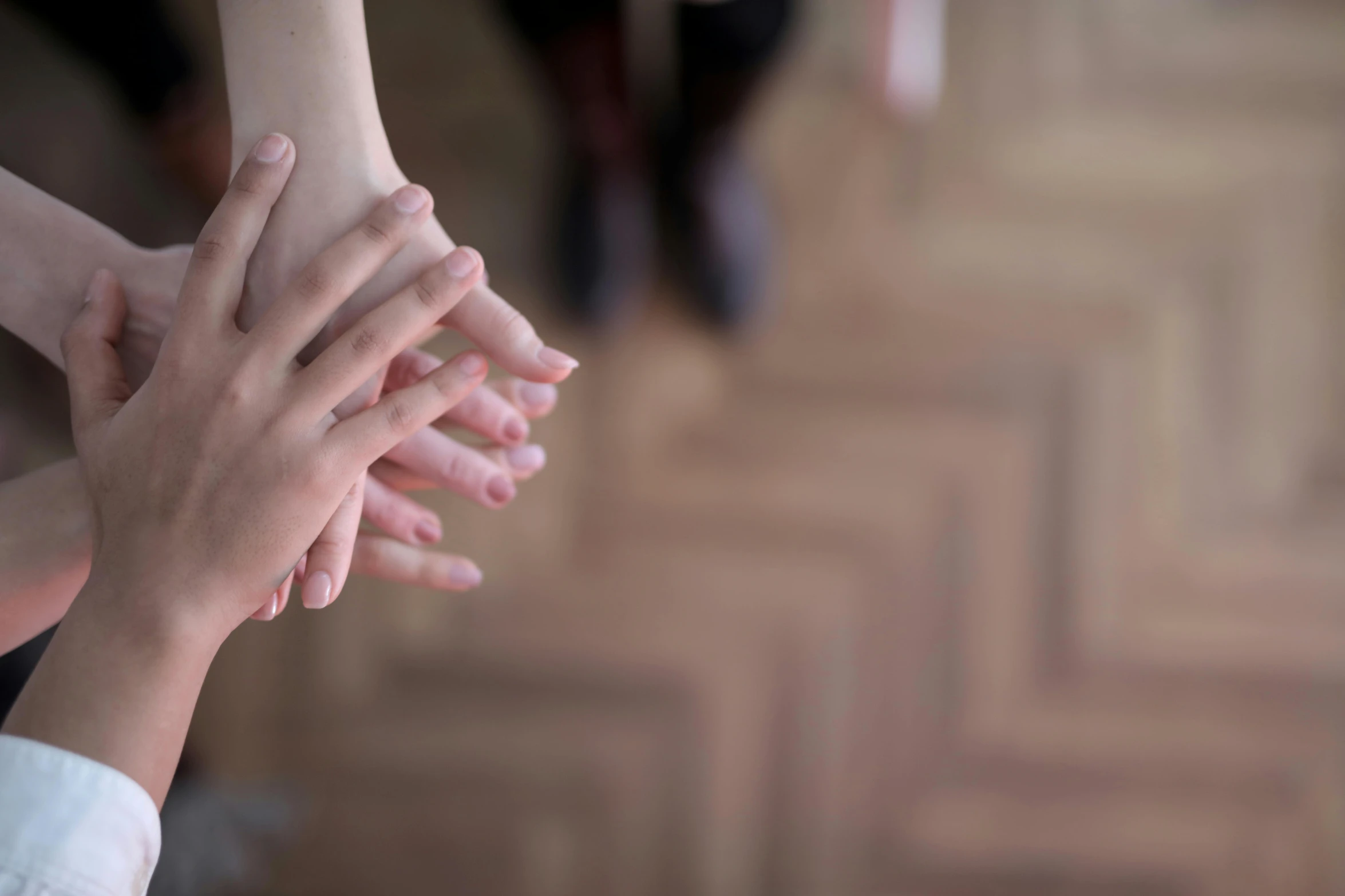 a group of people putting their hands together, antipodeans, fan favorite, from 8 k matte, highly realistic photograph, natural soft light