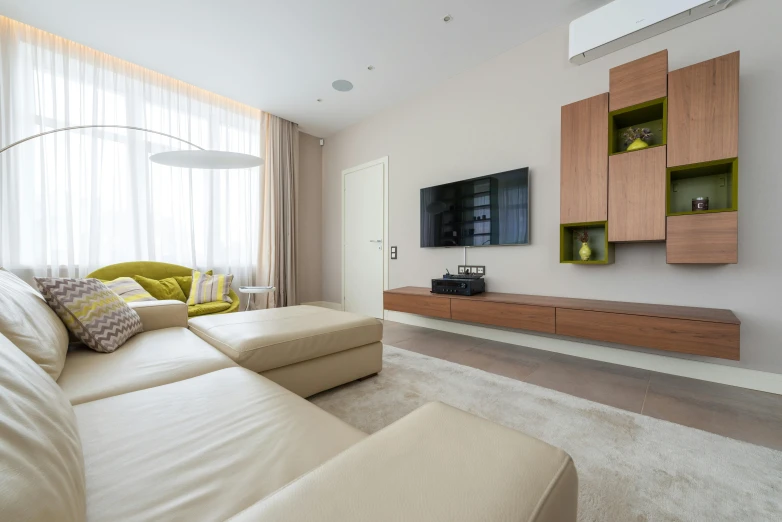 a living room filled with furniture and a flat screen tv, pexels contest winner, light and space, chartreuse color scheme, solid colours material, beige color scheme, white concrete floor
