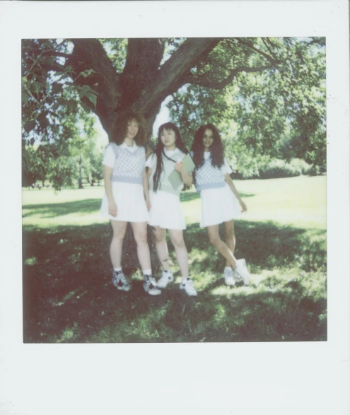 a group of young women standing next to a tree, a polaroid photo, inspired by Hannah Frank, melanie martinez, white hue, promotional still, three views
