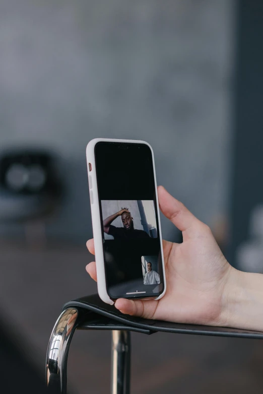 a person taking a picture with their cell phone, trending on pexels, home video footage, ios app icon, from 8 k matte, unsettling image