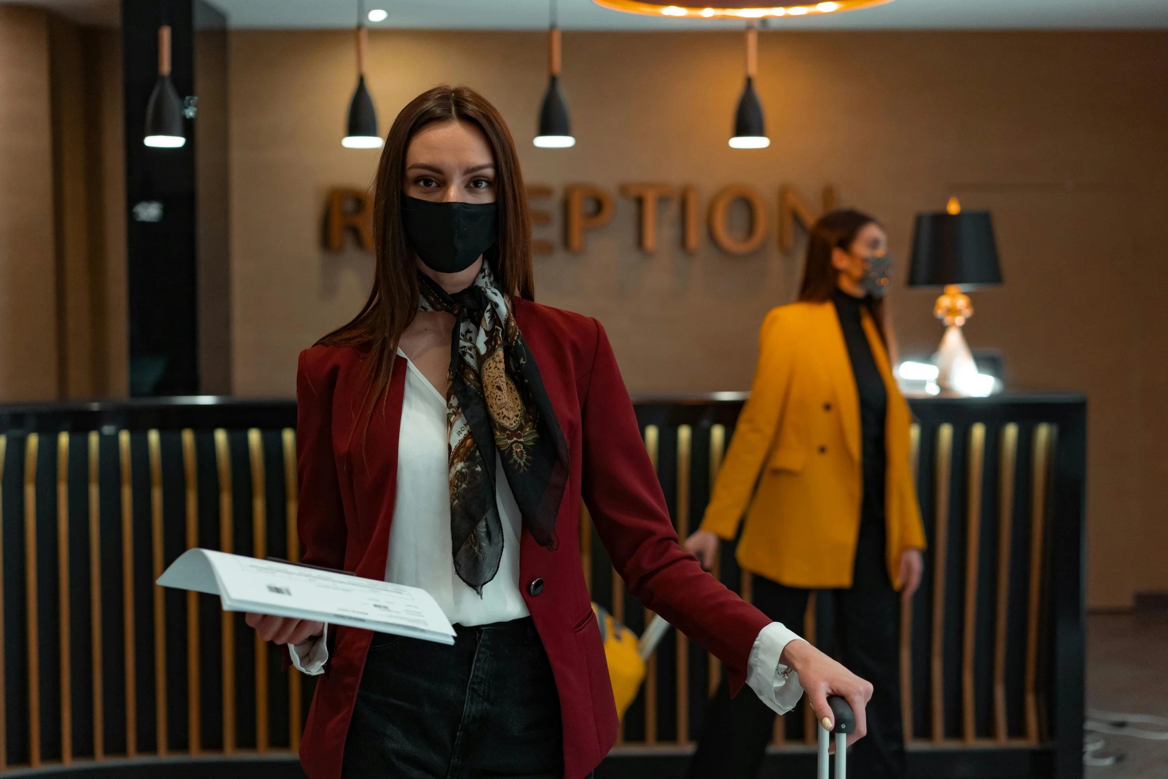 a woman wearing a face mask and carrying a suitcase, pexels contest winner, hotel, wearing black vest and skirt, wearing a turtleneck and jacket, fancy dress