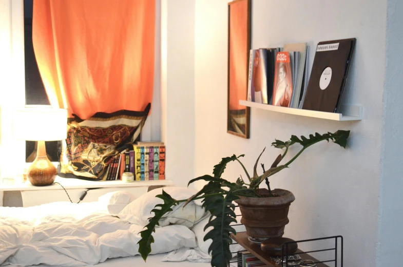 a bed room with a neatly made bed and a plant, inspired by Elsa Bleda, trending on unsplash, maximalism, white and orange, liminal bookshop, kreuzberg, art station ”