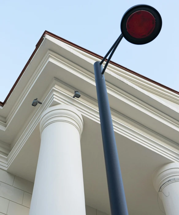 a street light on a pole in front of a building, by David Donaldson, neoclassical police station, crimson accents, detail structure, gallery lighting