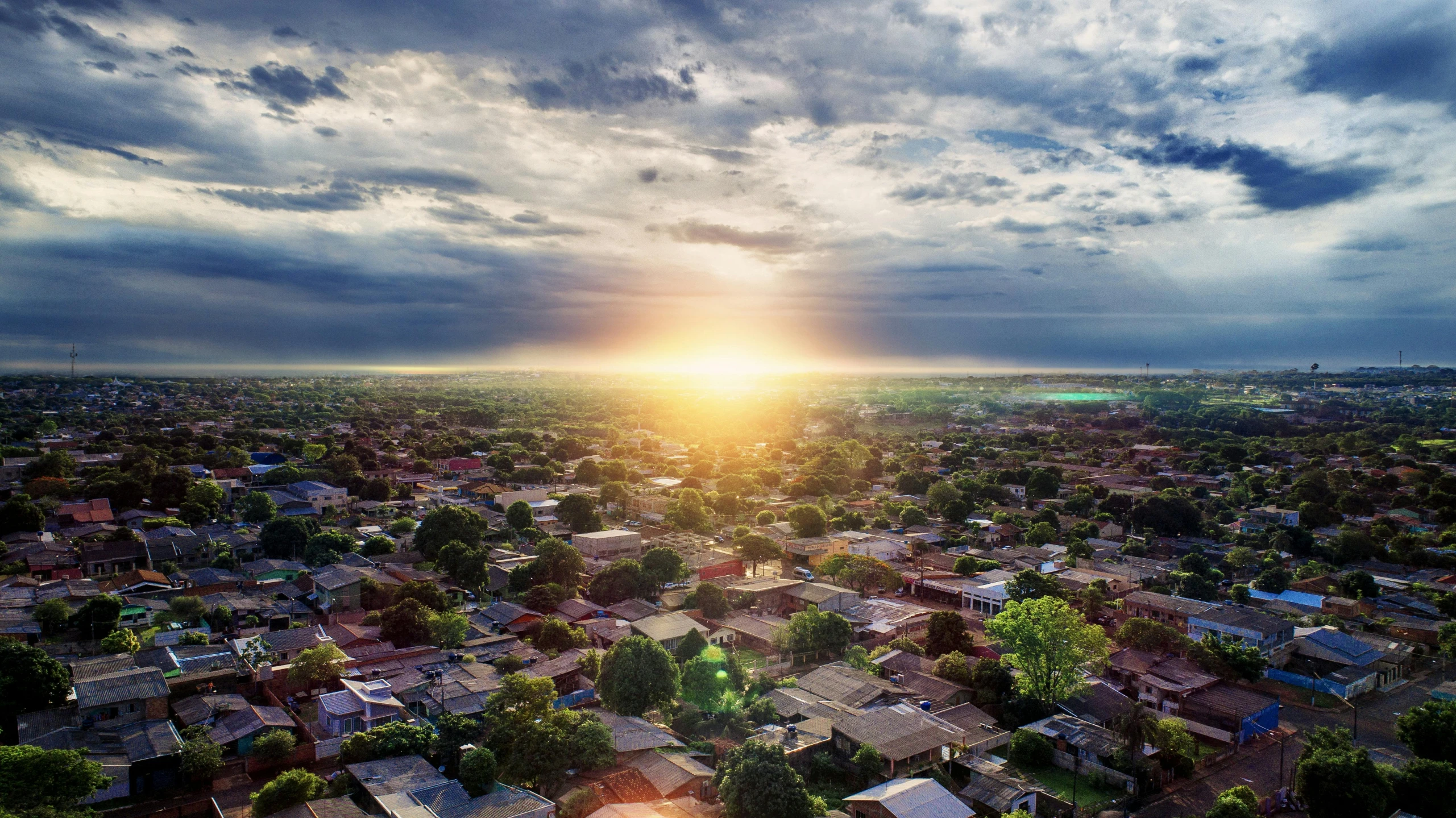 an aerial view of a city at sunset, shutterstock, fantastic realism, suburban neighborhood, lens flare photo real, high angle uhd 8 k, horizon view