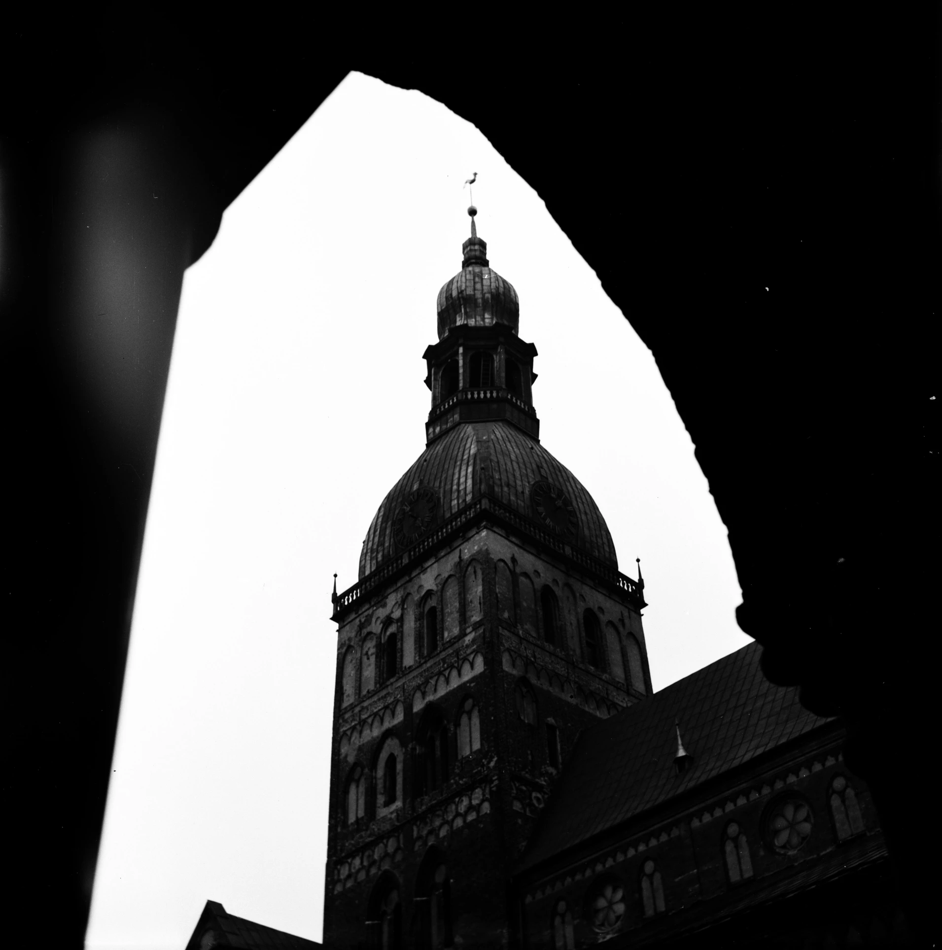 a black and white photo of a clock tower, by Tobias Stimmer, unsplash, romanesque, dome, hannover, obscured underexposed view, scanned