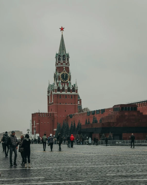 a group of people walking in front of a clock tower, inspired by Vasily Surikov, pexels contest winner, socialist realism, gray skies, red square, gif, 🚿🗝📝