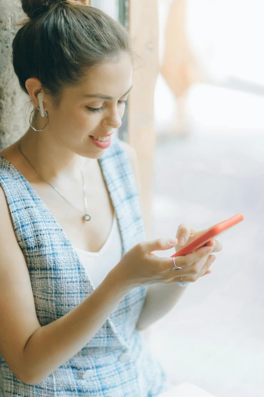 a woman is looking at her cell phone, trending on pexels, portrait of modern darna, promo image, square, casually dressed