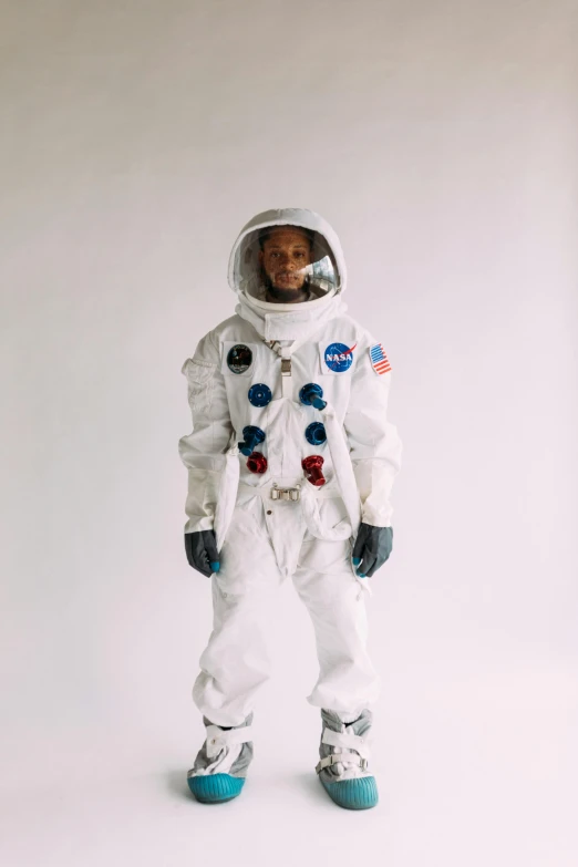 a man in an astronaut suit posing for a picture, an album cover, by Winona Nelson, trending on unsplash, hyperrealism, irving penn, joe biden full body portrait, wiz khalifa, lunar themed attire