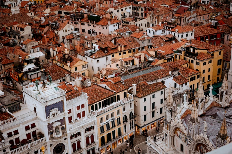 a view of a city from the top of a building, a photo, inspired by Canaletto, pexels contest winner, baroque, venice biennale, square, brown, colorful houses