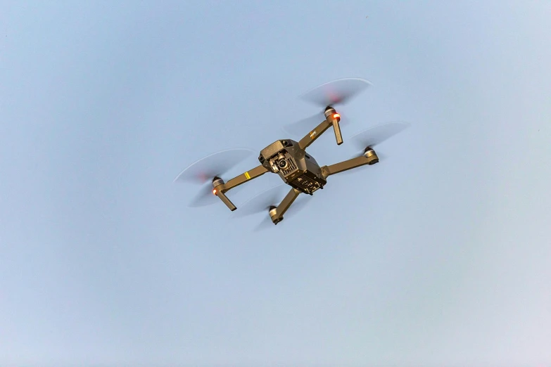 a small propeller plane flying through a blue sky, by Matthias Stom, pexels, renaissance, police drones, brown, gold, 2 0 0 0's photo