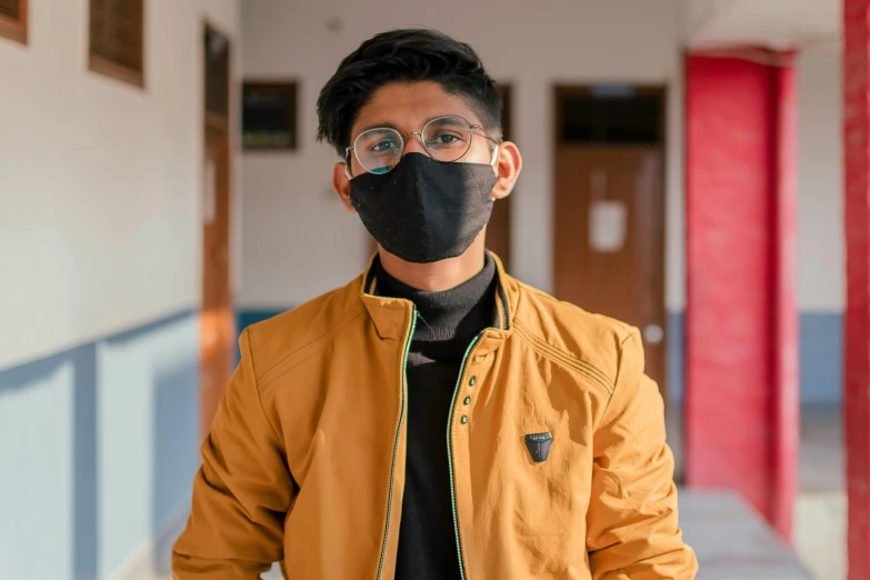 a man wearing a face mask standing in a hallway, pexels contest winner, quito school, avatar image, androgynous person, nepal, headshot profile picture