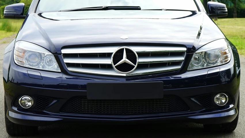 the front of a blue mercedes benz benz benz benz benz benz benz benz benz benz benz benz, by John Murdoch, pexels contest winner, taken in the late 2010s, extremely polished, frontal realistic, with a white muzzle