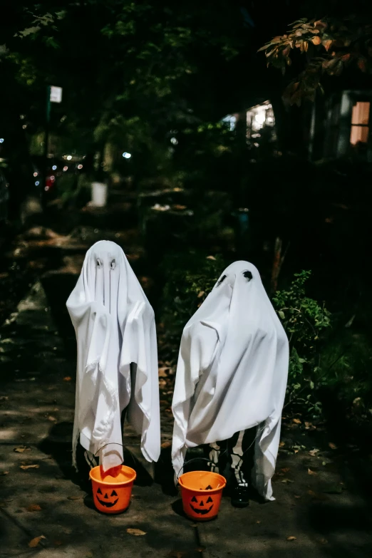 a couple of people in ghost costumes standing next to each other, pexels contest winner, happening, walking away from camera, ( ( theatrical ) ), twins, instagram photo
